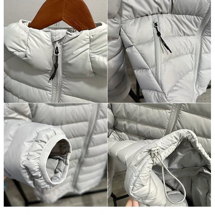 Jakna s kapuljačom, punjenje od bijelog patkina perja 85–90%, vanjski najlonski materijal, uski kroj, srednja duljina 50–65 cm