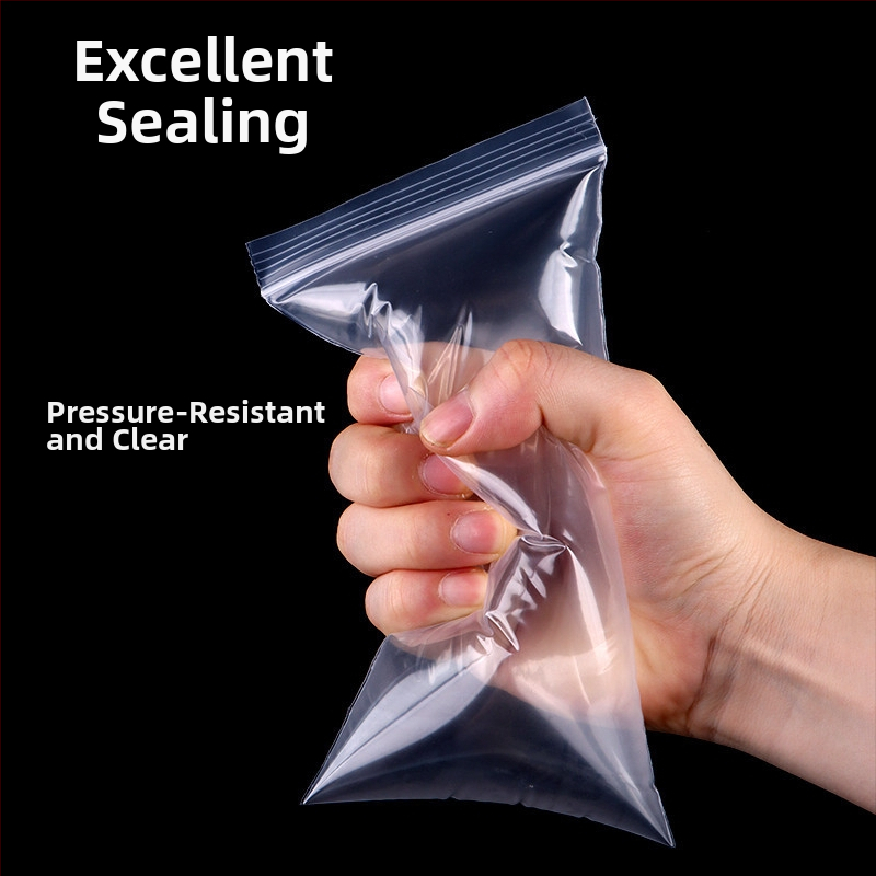 Storas, skaidrus atsparus vandeniui ir dulkių apsaugos kišenė su savisaugos užsegimu, skirta mobiliojo telefono pakuotei; medžiaga: naujasis PE; užsegimo ilgis: 1–1,5 cm; pritaikomas