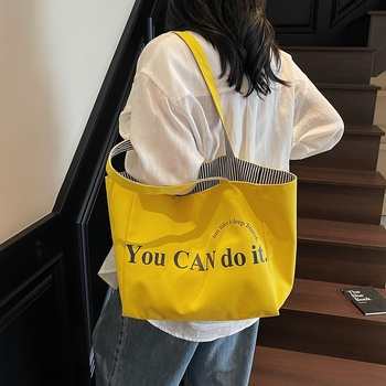 Canvas tote taška v mestskom minimalistickom štýle, horizontálne štvorcový tvar, otvorený vrch, dvojité ramienka, vnútorné vrecká na telefón a ID, podšívka z polyesteru a bavlny, značka Nido, jar 2025