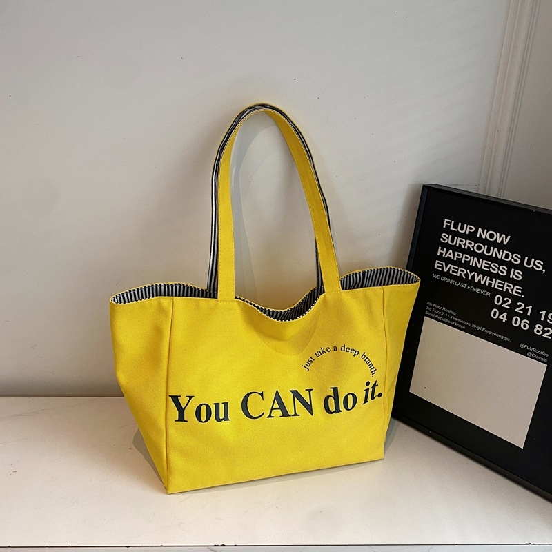 Canvas tote taška v mestskom minimalistickom štýle, horizontálne štvorcový tvar, otvorený vrch, dvojité ramienka, vnútorné vrecká na telefón a ID, podšívka z polyesteru a bavlny, značka Nido, jar 2025