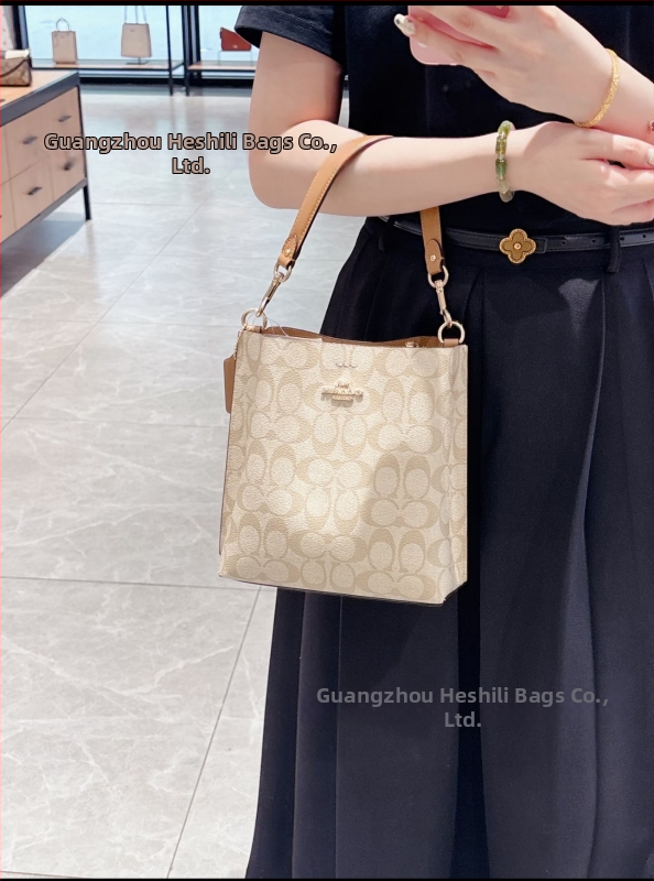 Mollie taška typu vedro z pravej kože; vertikálny štvorcový tvar; magnetické zapínanie; vnútorné vrecká: vrecko na telefón a laminované zipsové vrecko; dvojité remene