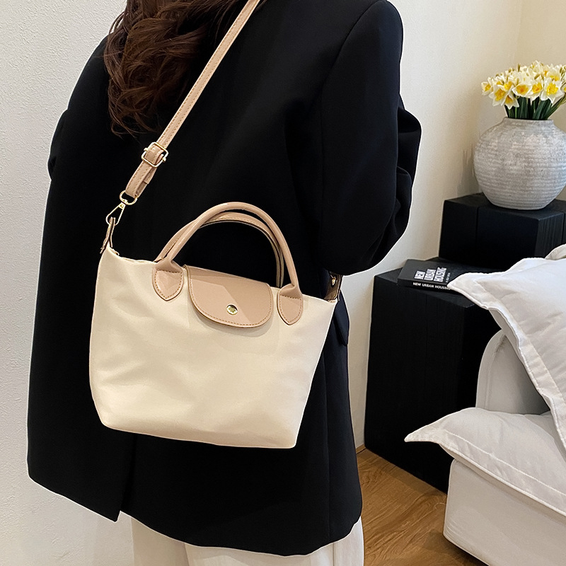 Crossbody táska, dumpling-stílus, nylon anyagból, fedéllel és cipzáras zárással, városi minimalizmus