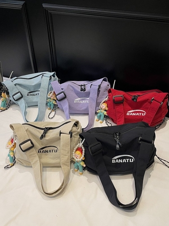 Női crossbody táska utcai stílusban, vízszintes négyszögletes forma, vászon anyag, cipzáras zárás.