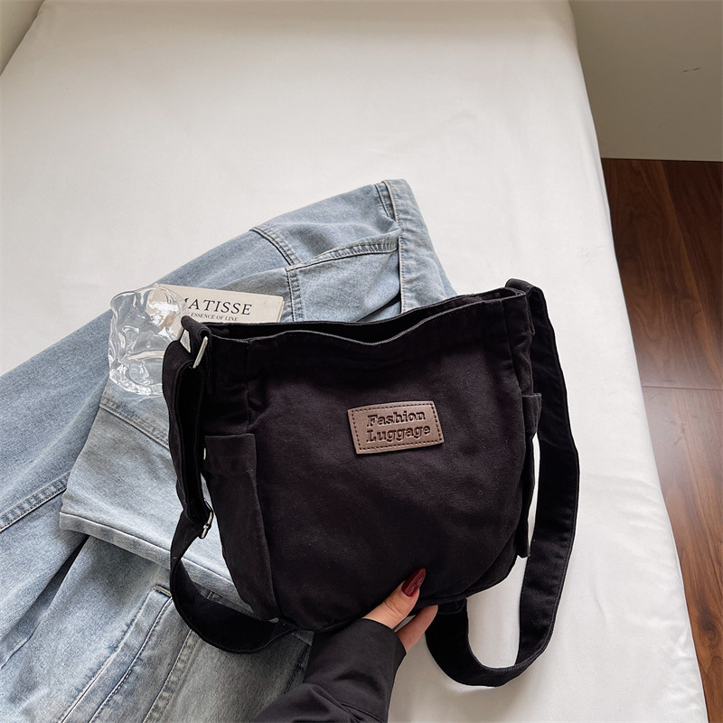 Crossbody torba od platna, horizontalni kvadratni oblik, zatvaranje na zip, unutarnja pretinica za mobitel, jedna naramenica