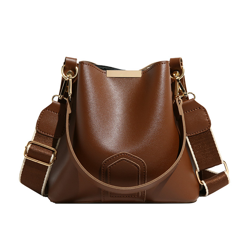 Bucket taška — PU materiál, oválny tvar, magnetické zapínanie, vnútorné vrecká so zipsom, vrecko na telefón, vrecko na ID, jar 2025