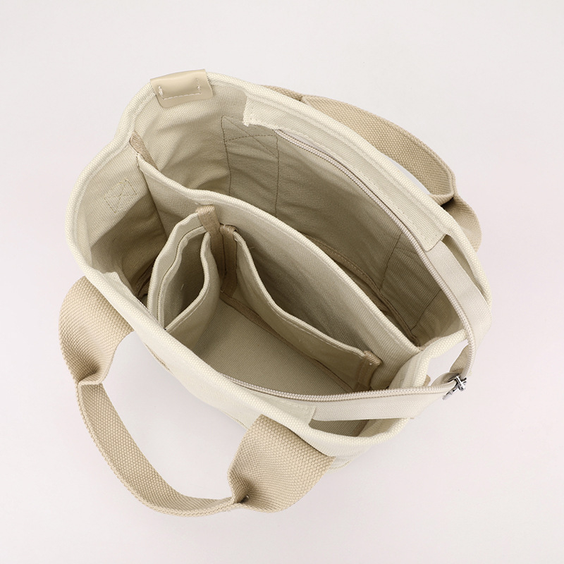 Ženska torba od kanvasa, gradski stil jednostavnosti, vodoravni kvadratni oblik, zatvaranje zipom, unutarnji pretinci za telefon, ID karticu i laminirani džep sa zipom