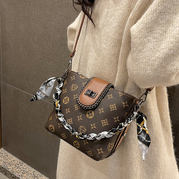 Geantă bucket din PU, formă verticală pătrată, închidere cu fermoar, căptușeală din poliester, o singură curea de umăr.