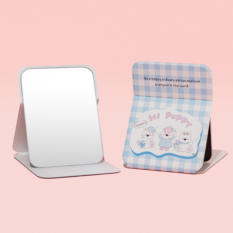 Összecsukható asztali sminktükör aranyos rajzolt kiskutyás dizájnnal (keret: PU/PS/PVC; lencse: üveg; testreszabás elérhető; logó nyomtatás lehetséges; ideális ajándék, esküvők, születésnapok vagy költöztetés esetén)