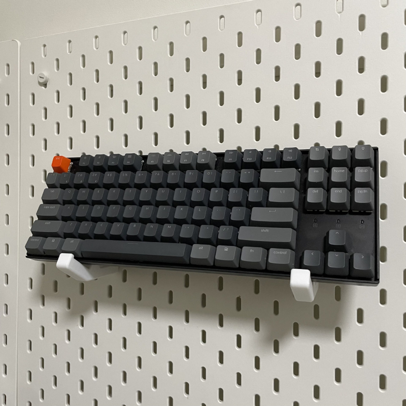 Skadis universālais mehāniskais tastatūras turētājs perforētajam panelim