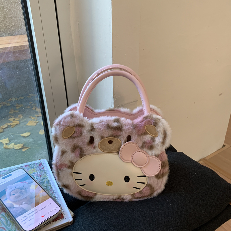 Gyerekeknek szánt rajzfilmszerű oldaltáska macska motívummal (Nylon; kerek forma; cipzáras záródás; belső cipzáros rekesz; egyoldali vállpánt)