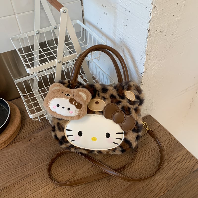 Gyerekeknek szánt rajzfilmszerű oldaltáska macska motívummal (Nylon; kerek forma; cipzáras záródás; belső cipzáros rekesz; egyoldali vállpánt)