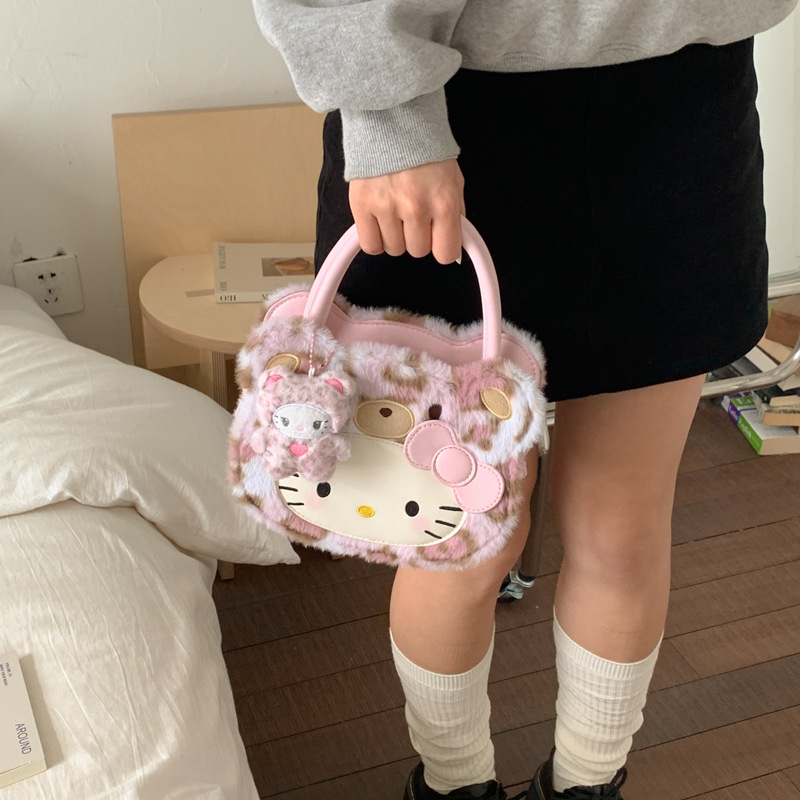 Gyerekeknek szánt rajzfilmszerű oldaltáska macska motívummal (Nylon; kerek forma; cipzáras záródás; belső cipzáros rekesz; egyoldali vállpánt)