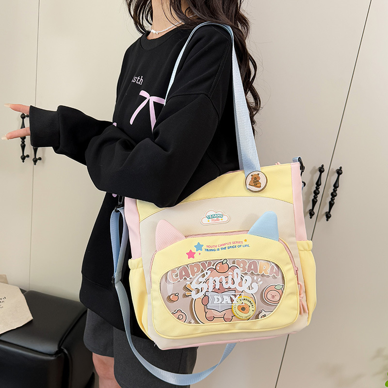 Nylonból készült crossbody táska lányoknak iskolai használatra, rajzfilm-stílus, kopásálló, csökkenti a terhelést, tárolható, poliészter bélés
