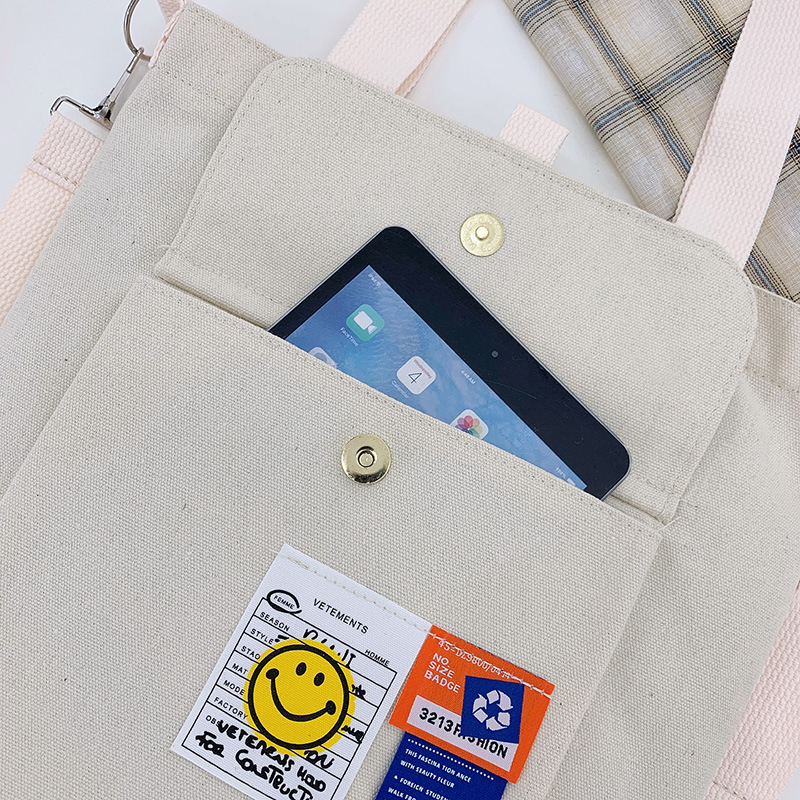 Torba preko ramena od platna, gradski minimalistički stil, uspravni kvadratni oblik, zatvarač, unutarnje pretinice za laptop, karticu/ID, pretinica sa zatvaranjem