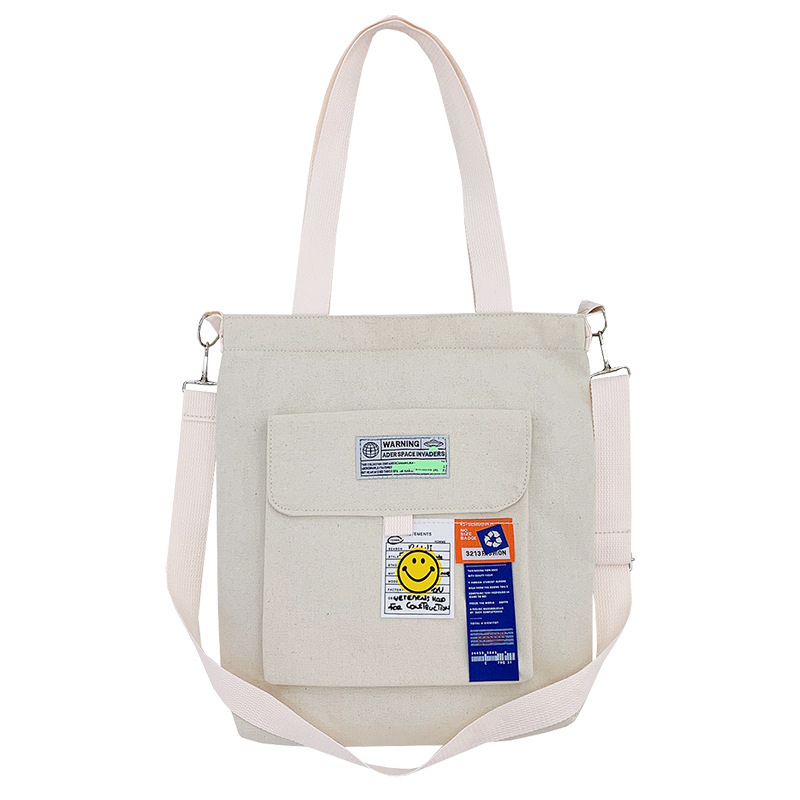 Torba preko ramena od platna, gradski minimalistički stil, uspravni kvadratni oblik, zatvarač, unutarnje pretinice za laptop, karticu/ID, pretinica sa zatvaranjem