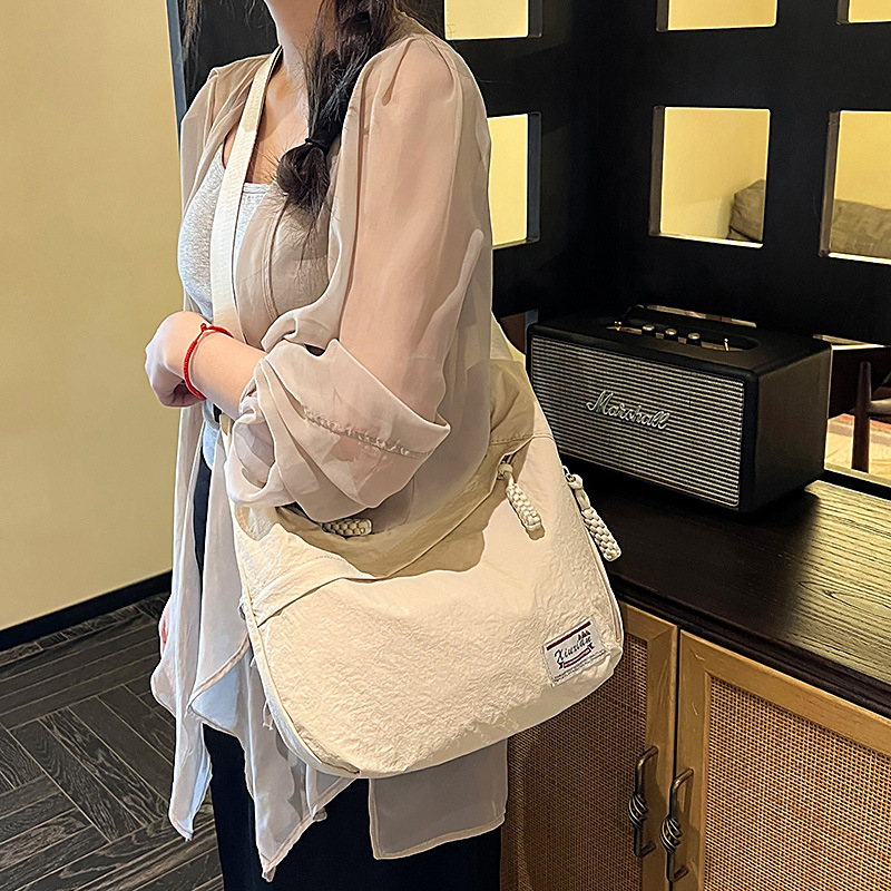 Nylon dumpling alakú crossbody táska, cipzárral, telefontartó zsebbel, poliészter bélés, egyetlen vállpánt