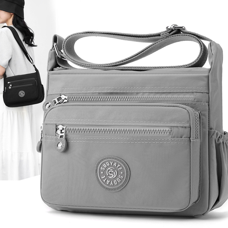 Nylon keresztpántos táska, vízálló, cipzáras zárás, nagy kapacitású belső zsebbel (telefonzseb és zipzáras zseb), vászon bélés