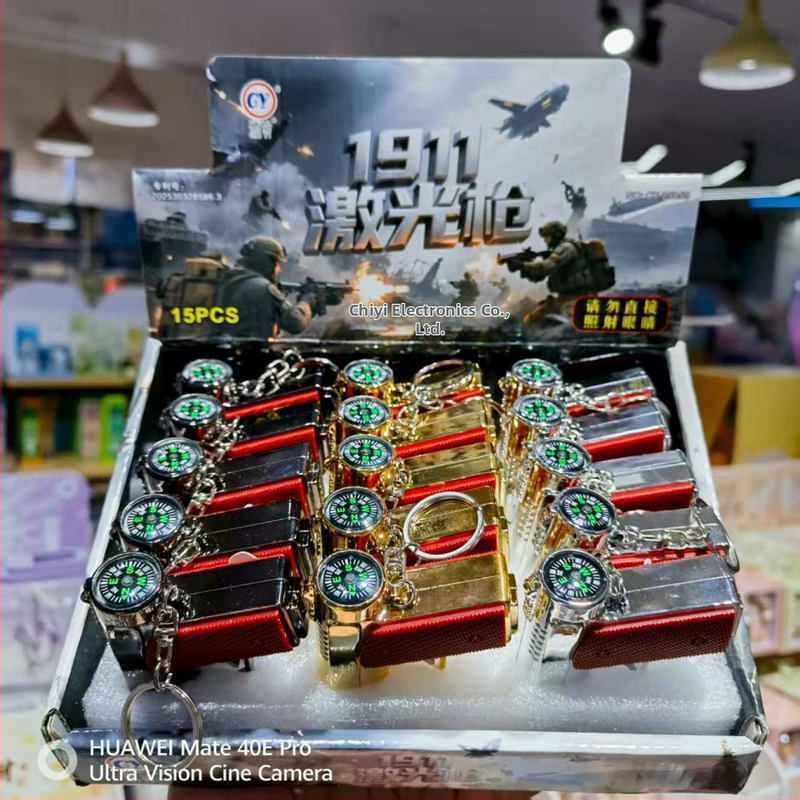 Viacfunkčná hračková pištoľ s LED osvetlením, infračerveným laserom a príveskom s kompasom; plastová konštrukcia, od 14 rokov, interaktívna hračka