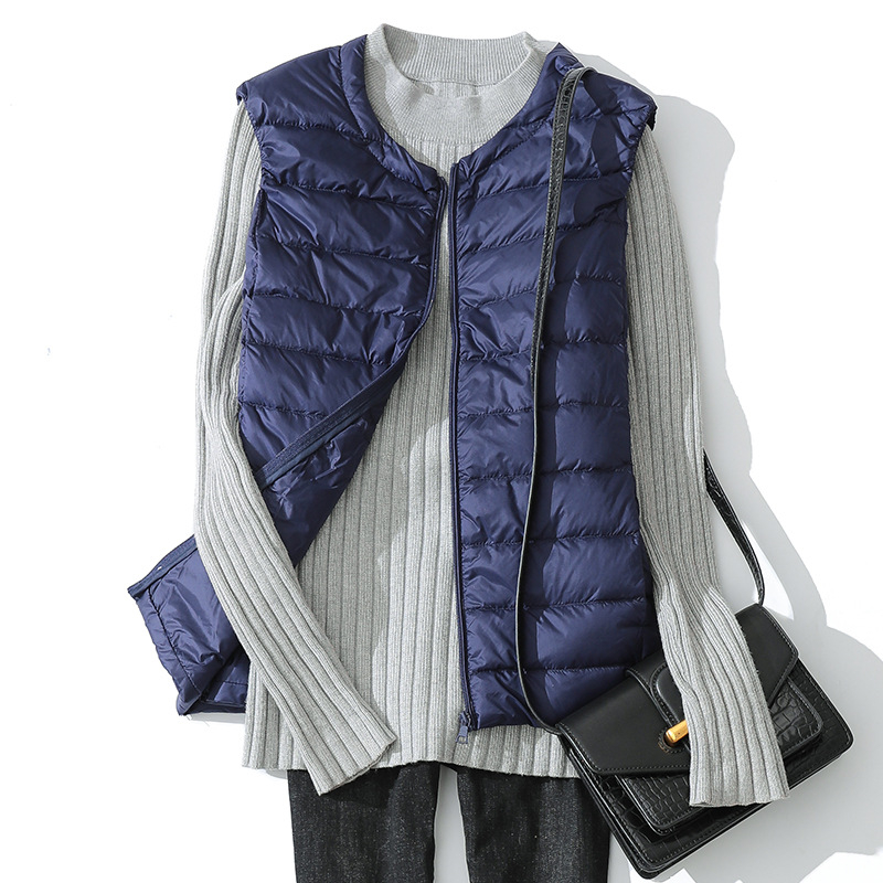 Vesta de damă din puf subțire, cu exterior din nylon, guler rotund și fermoar (umplutură: puf de rață alb; material: nylon; grosime: subțire; guler: rotund; închidere: fermoar)