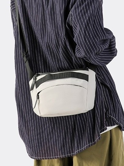 Unisex najlon crossbody torba sa zatvaračem, ovalni oblik, jednoručna naramenica, džep za telefon i dokumente.