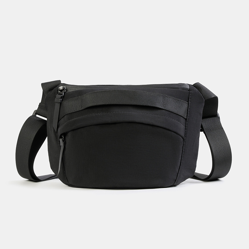 Unisex najlon crossbody torba sa zatvaračem, ovalni oblik, jednoručna naramenica, džep za telefon i dokumente.