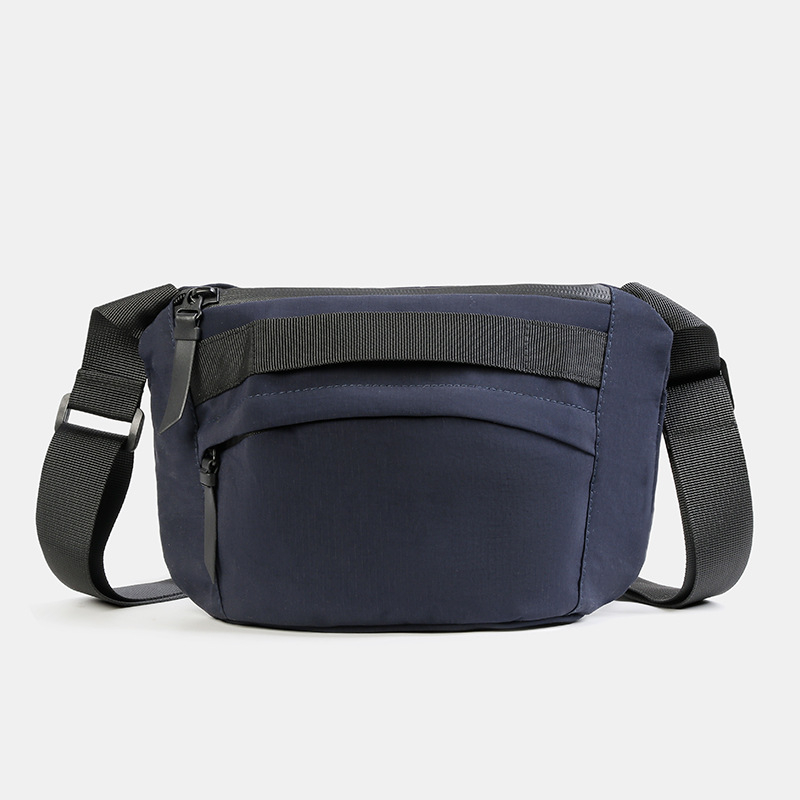 Unisex najlon crossbody torba sa zatvaračem, ovalni oblik, jednoručna naramenica, džep za telefon i dokumente.