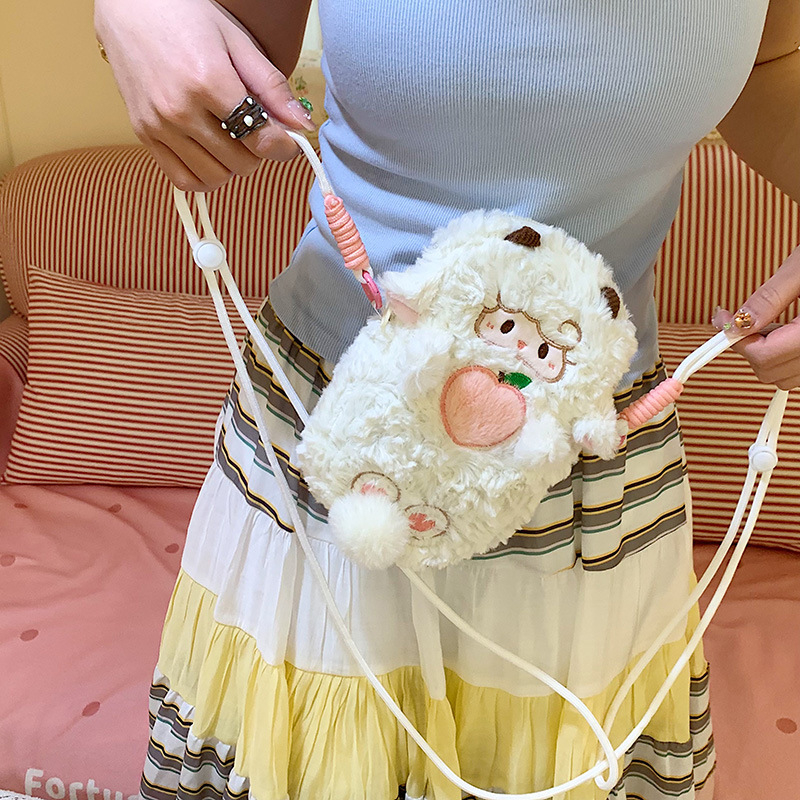 Crossbody torba od veluru, cilindričnog oblika, zatvarač s poklopcem, unutarnja pregrada za mobitel