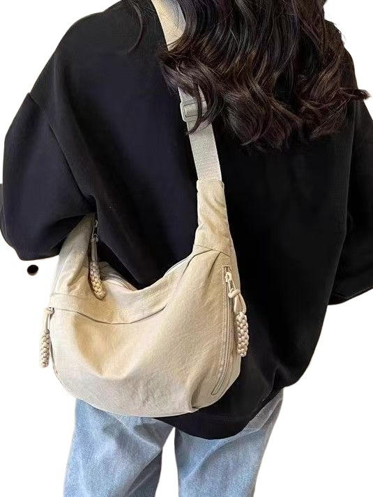 Crossbody torba u stilu dumpling bun, vanjski dio od najlona s podlogom od poliestera, unisex dizajn, proljeće 2025 lansiranje, za svakodnevnu uporabu.