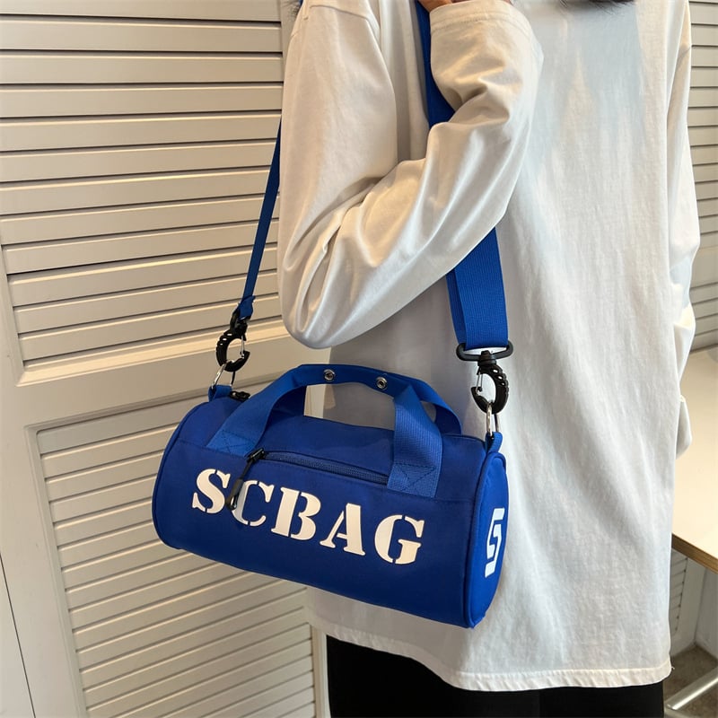 Geantă crossbody, stil japonez, nylon, design cilindric bucket, închidere cu fermoar, buzunar cu fermoar în interior și buzunar pentru telefon.