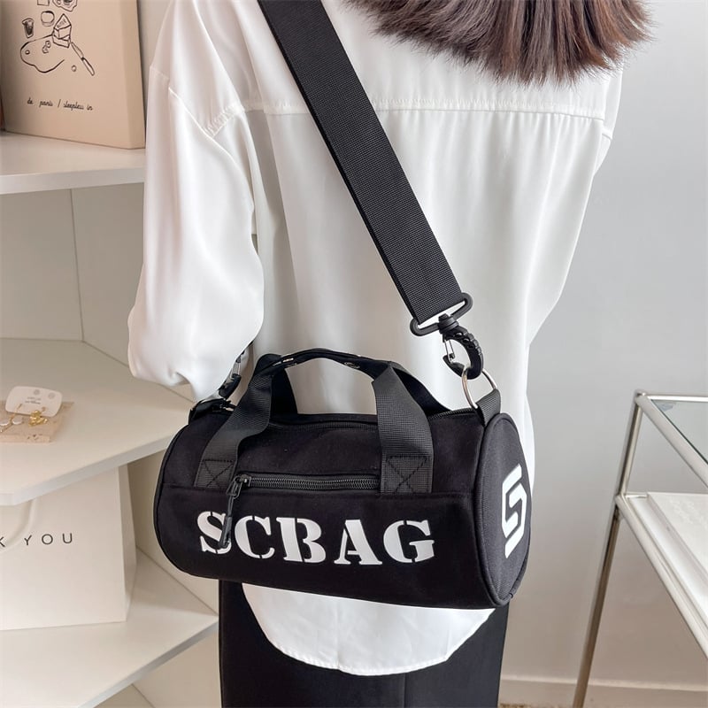 Geantă crossbody, stil japonez, nylon, design cilindric bucket, închidere cu fermoar, buzunar cu fermoar în interior și buzunar pentru telefon.