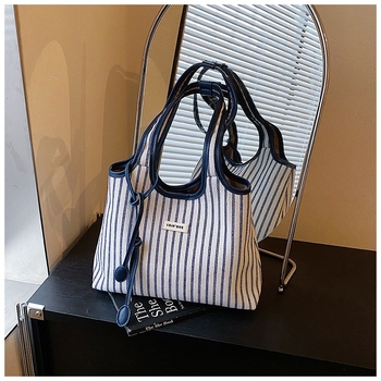 Šarena platnena tote torba — gradski stil, platnen materijal, vertikalni kvadratni oblik, magnetska zatvarač, unutarnji džep sa zipom i džep za telefon.