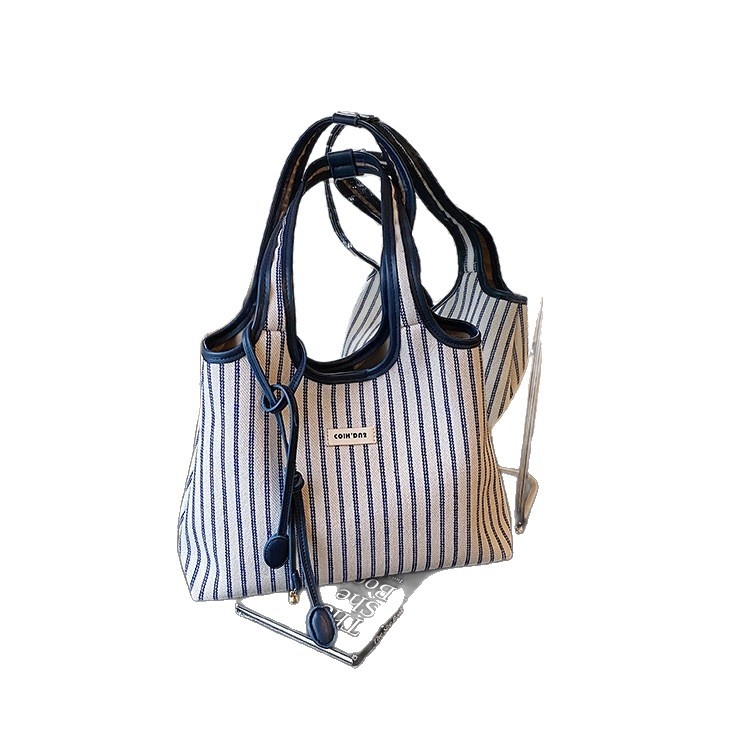 Šarena platnena tote torba — gradski stil, platnen materijal, vertikalni kvadratni oblik, magnetska zatvarač, unutarnji džep sa zipom i džep za telefon.