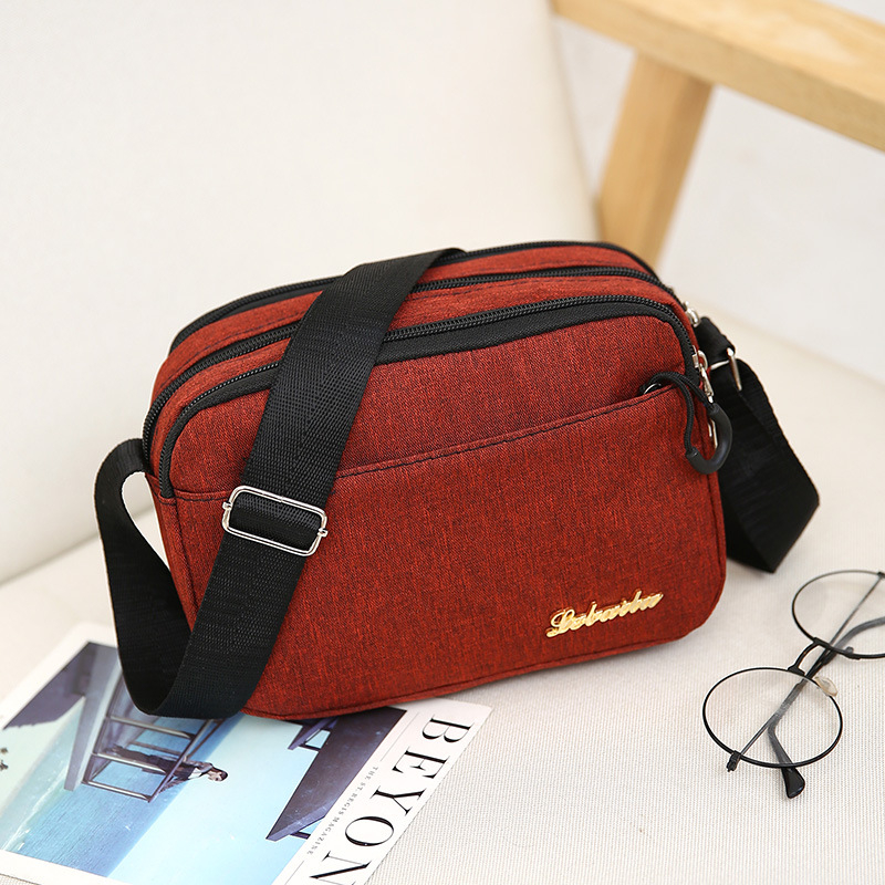Ženska crossbody torba, kvadratnog oblika, Oxford plat, zatvarač, poliester podstava, jedna naramenica, urbani minimalistički stil