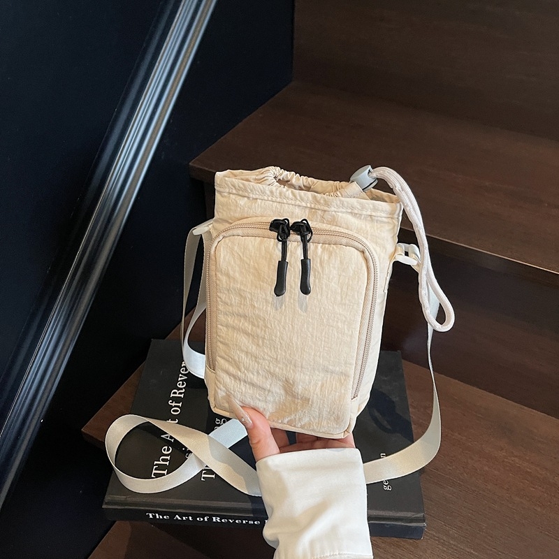 Crossbody torba s vertikalnim kvadratnim oblikom – Oxford tkanina, otvaranje špagom, unutarnja džep sa zipom, poliester podstava, ljeto 2025