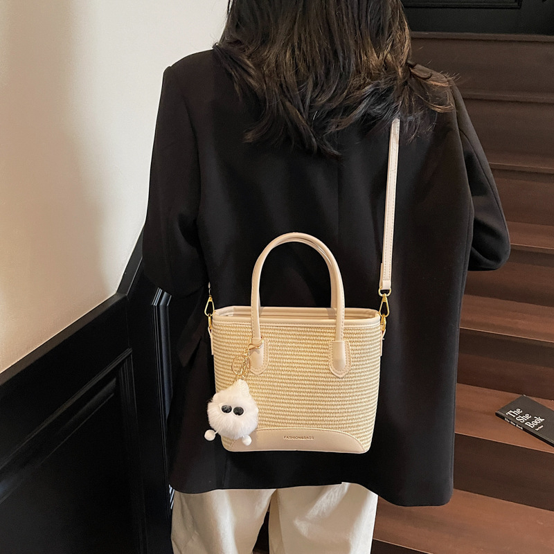 Dámska taška bucket zo slamy – ľahká, univerzálna cez rameno so zipsom, horizontálny štvorcový tvar, vnútorné vrecká na telefón a ID, mestský minimalizmus, jar 2025