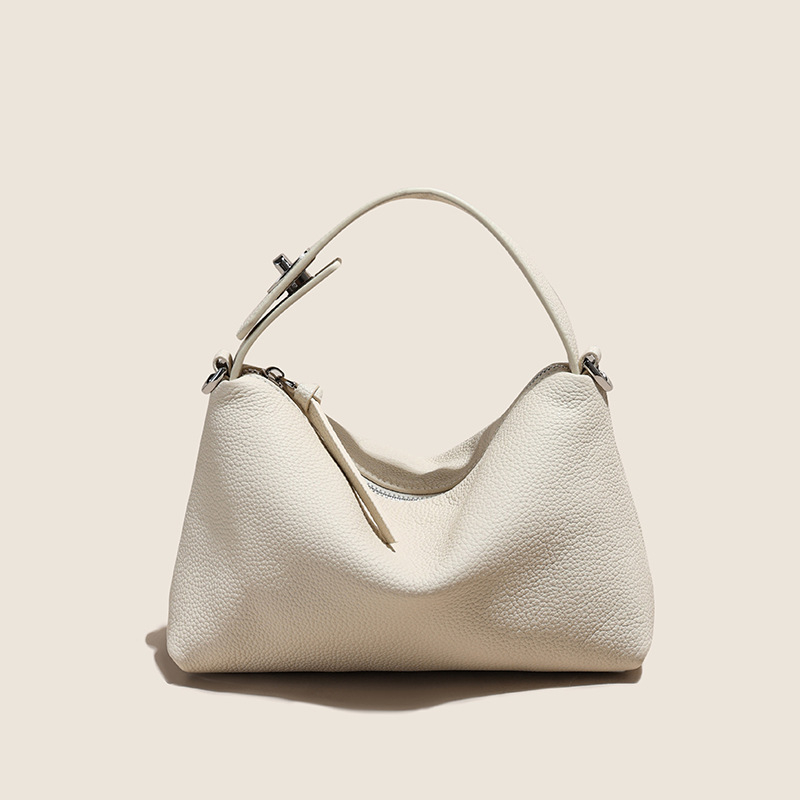 Első réteg marhabőrből készült tote táska, városi minimalistikus stílus, párnás alak, cipzáros zárás, belső zsebek telefon és ID számára