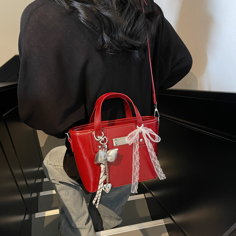 Ženska PU crossbody torbica, srednje veličine, oblik kante, zatvarač, poliester podstava, gradski minimalistički stil, svakodnevna upotreba, proljeće 2026