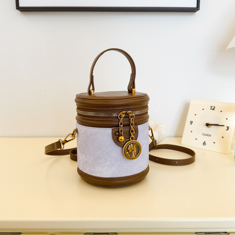 Jonica Ženska bucket torba: gradski minimalistički stil, PU materijal, cilindrični oblik, otvaranje preklopnim poklopcem