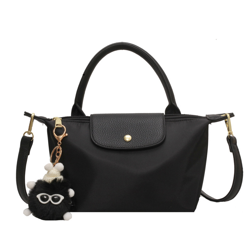 Crossbody torba od tkanine, vodoravnog kvadratnog oblika, zatvaranje kapom, unutarnji džep sa zipom, s jednim remenom