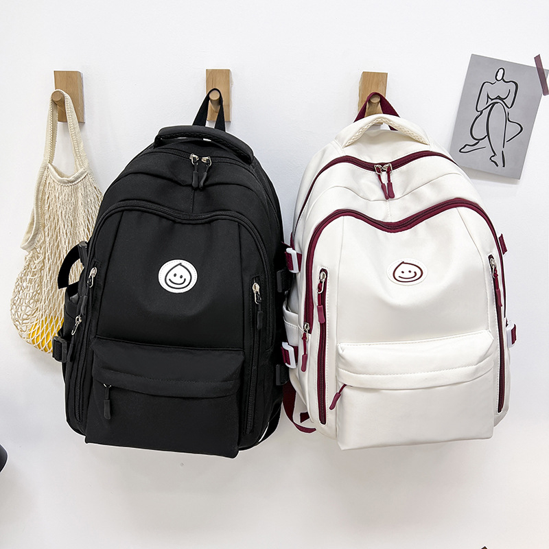 Unisex nailono kuprinė universitetui — ergonominis nugaros skydas, išplėtus talpą, miesto minimalistinis stilius, šypsenėlės spaudas