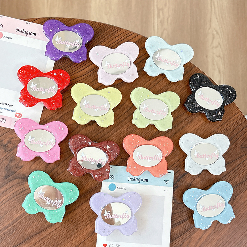 Asztali telefon-tartó csillogó pillangó díszítéssel, kis tükrövel, teleszkópos kar, ragasztóval rögzíthető, műanyag, univerzális kialakítás