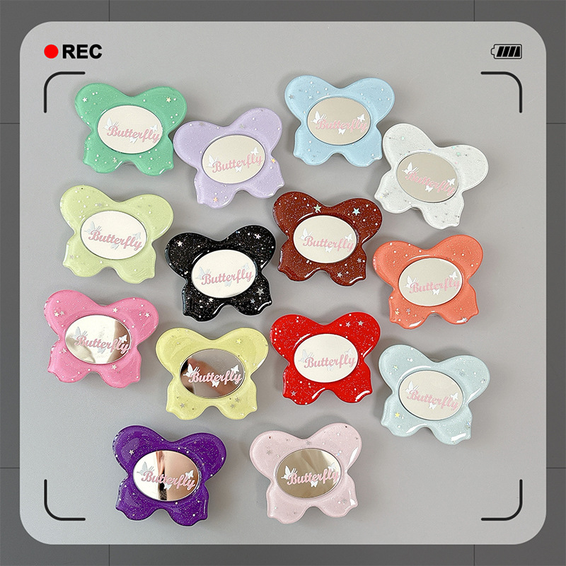 Asztali telefon-tartó csillogó pillangó díszítéssel, kis tükrövel, teleszkópos kar, ragasztóval rögzíthető, műanyag, univerzális kialakítás