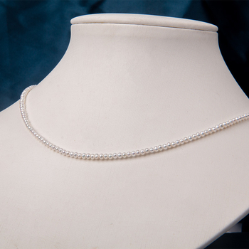 Édesvízi gyöngyökből készült nyaklánc, szinte kör alakú gyöngyök, 925-ös ezüst, rizs alakú gyöngyök díszítéssel, irodai minimalizmus stílus.