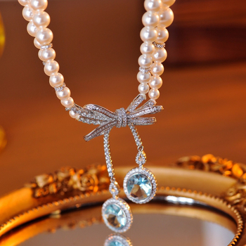 Κολιέ με σχήμα φιόγκο, ηλεκτροπλατιωμένο χαλκό-κράμα, μενταγιόν με ζιρκόν, μαργαριταρένια αλυσίδα