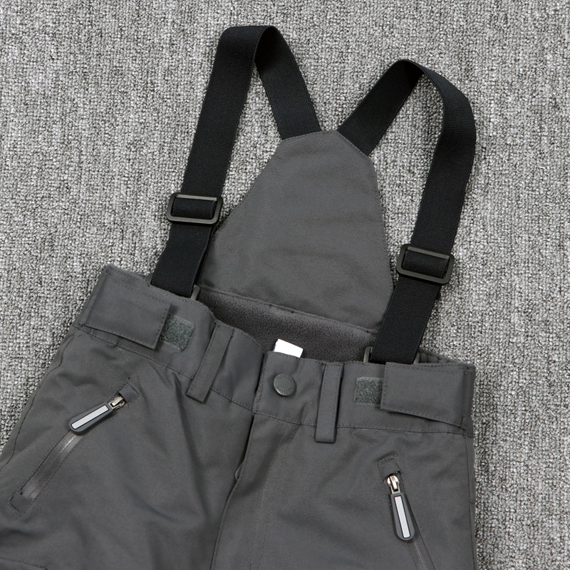 Gyerekeknek szóló egy darabos síoverál vállpántokkal – szélvédett, vízálló és meleg, 100% poliészter anyagú külső, pamut töltetű