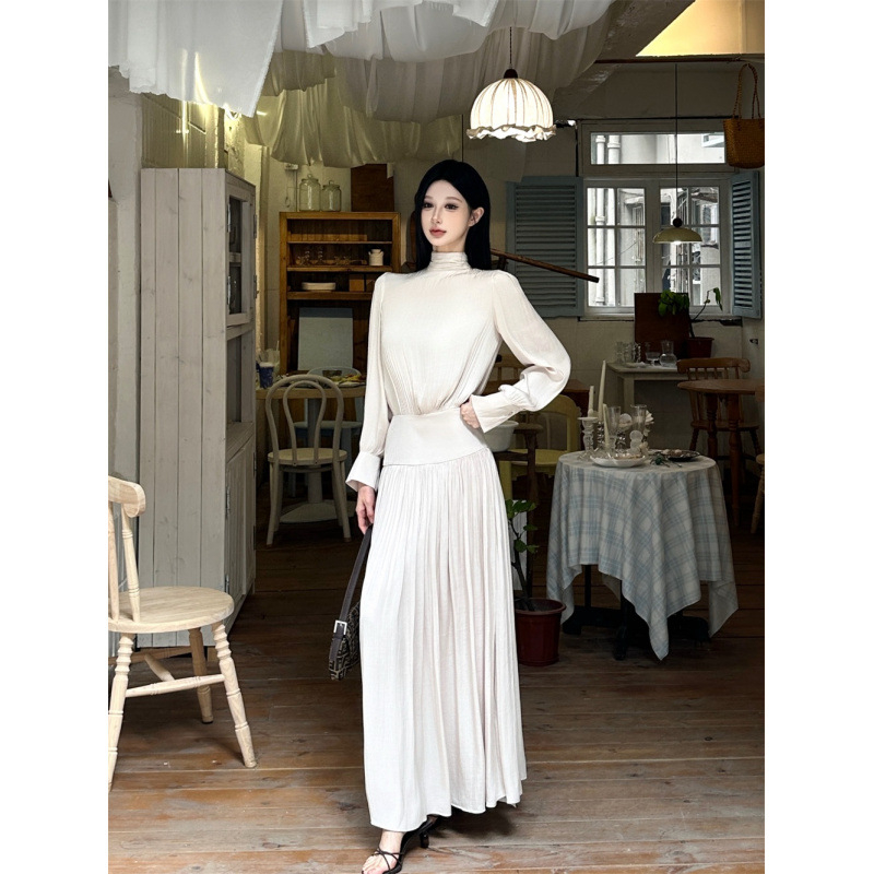 Дълга плисирана рокля от френски сатен, с дълги ръкави, кръгъл деколте и висока талия.