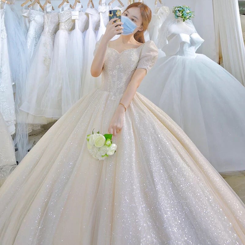 Rochie de mireasă cu trenă lungă, stil franțuzesc, decolteu adânc în V, mâneci trei sferturi, țesătură organza (conținut principal 30–50%)