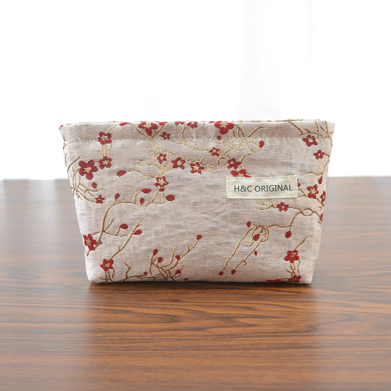 Ženska prijenosna kozmetička torbica s reljefnim cvjetnim uzorkom, poliester, podstava od platna, putni organizator