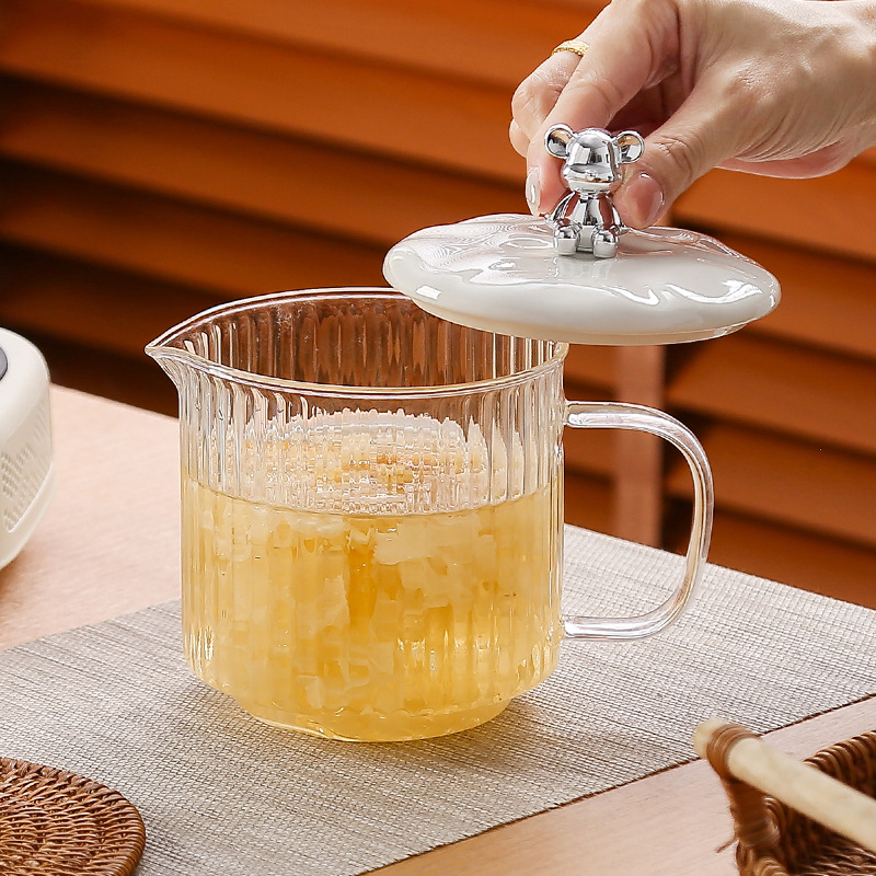Veselības tējas kanna no stikla ar smilšu tekstūras korpusu (1 L ietilpība; 220 V; 300–350 W; keramikas iekšējā tvertnes; šķidruma izplešanās termostats)