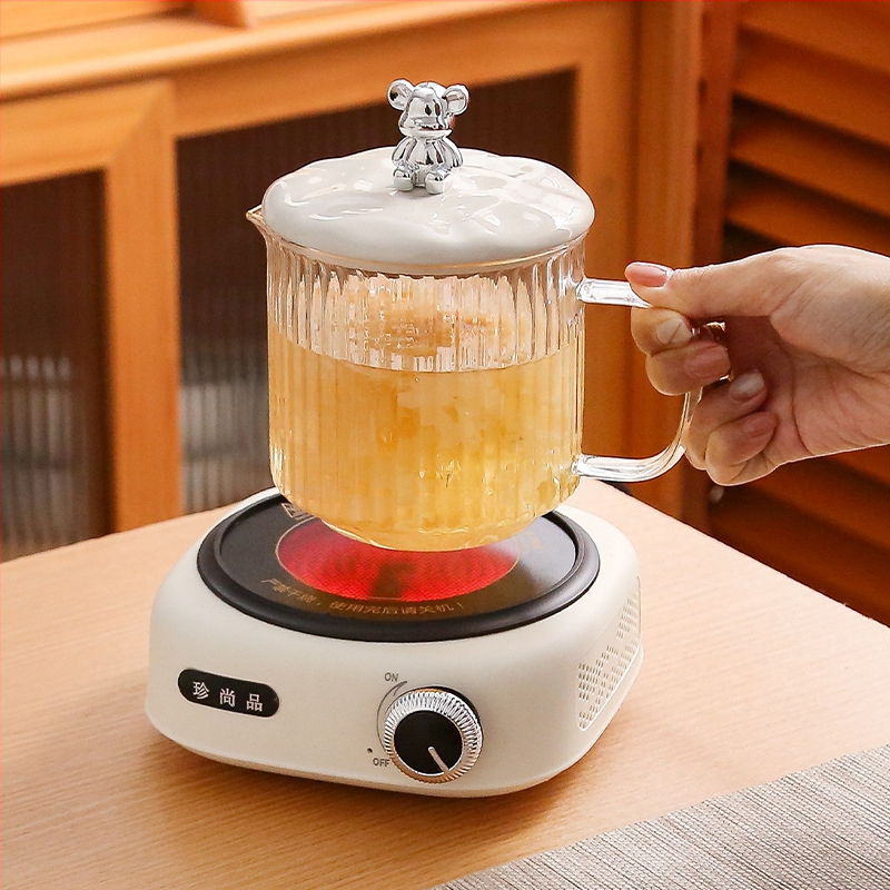 Veselības tējas kanna no stikla ar smilšu tekstūras korpusu (1 L ietilpība; 220 V; 300–350 W; keramikas iekšējā tvertnes; šķidruma izplešanās termostats)